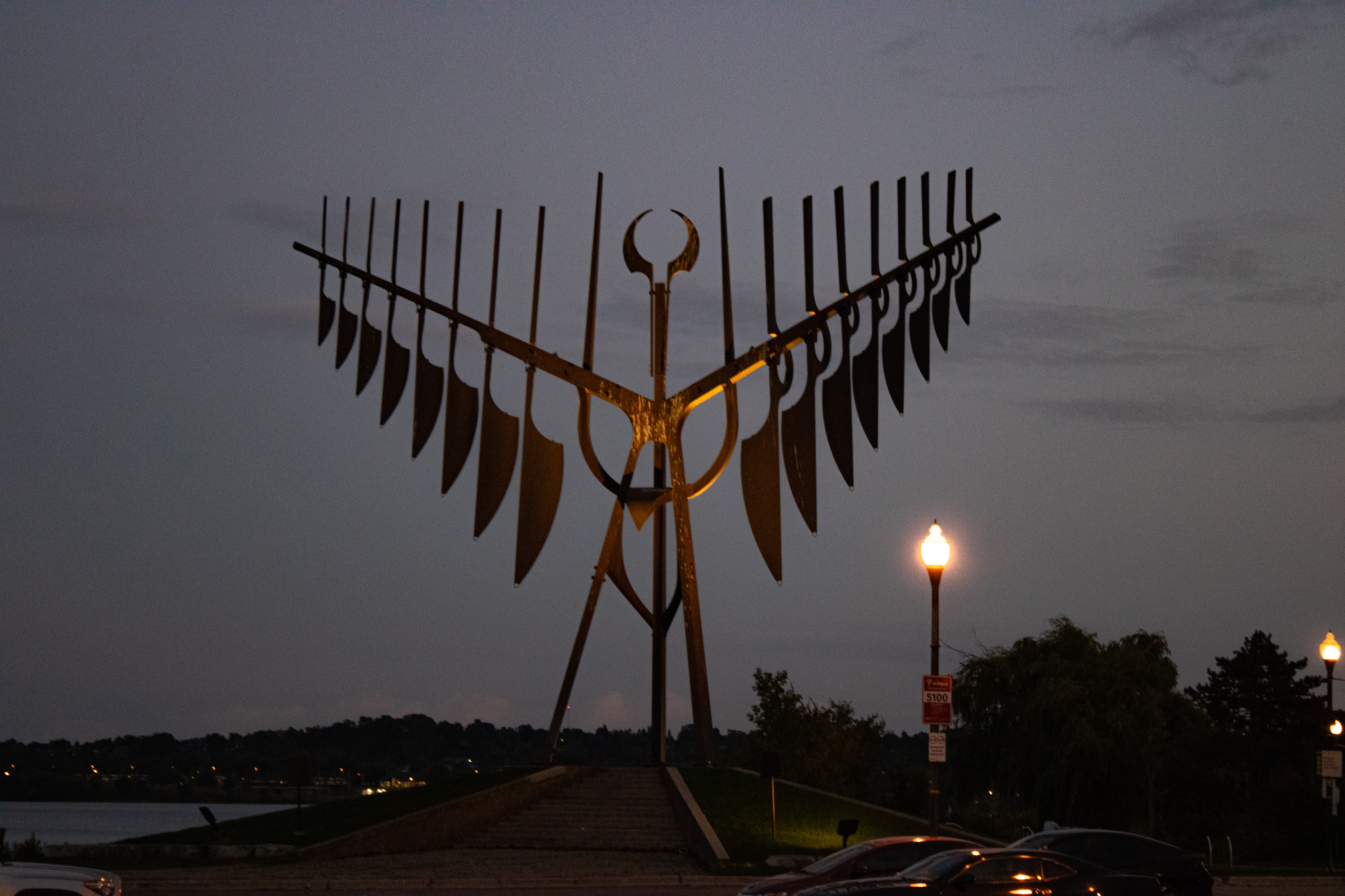 Large metal bird sculpture at dusk